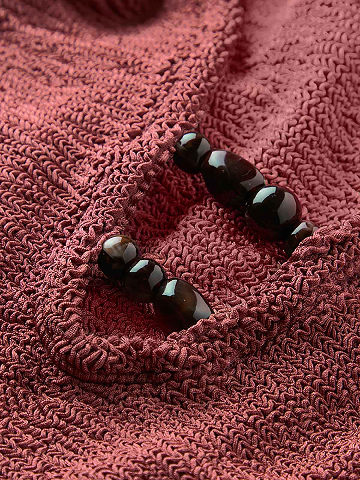 Close up of Metallic Rosewood Adriana beaded swimsuit fabric and beads