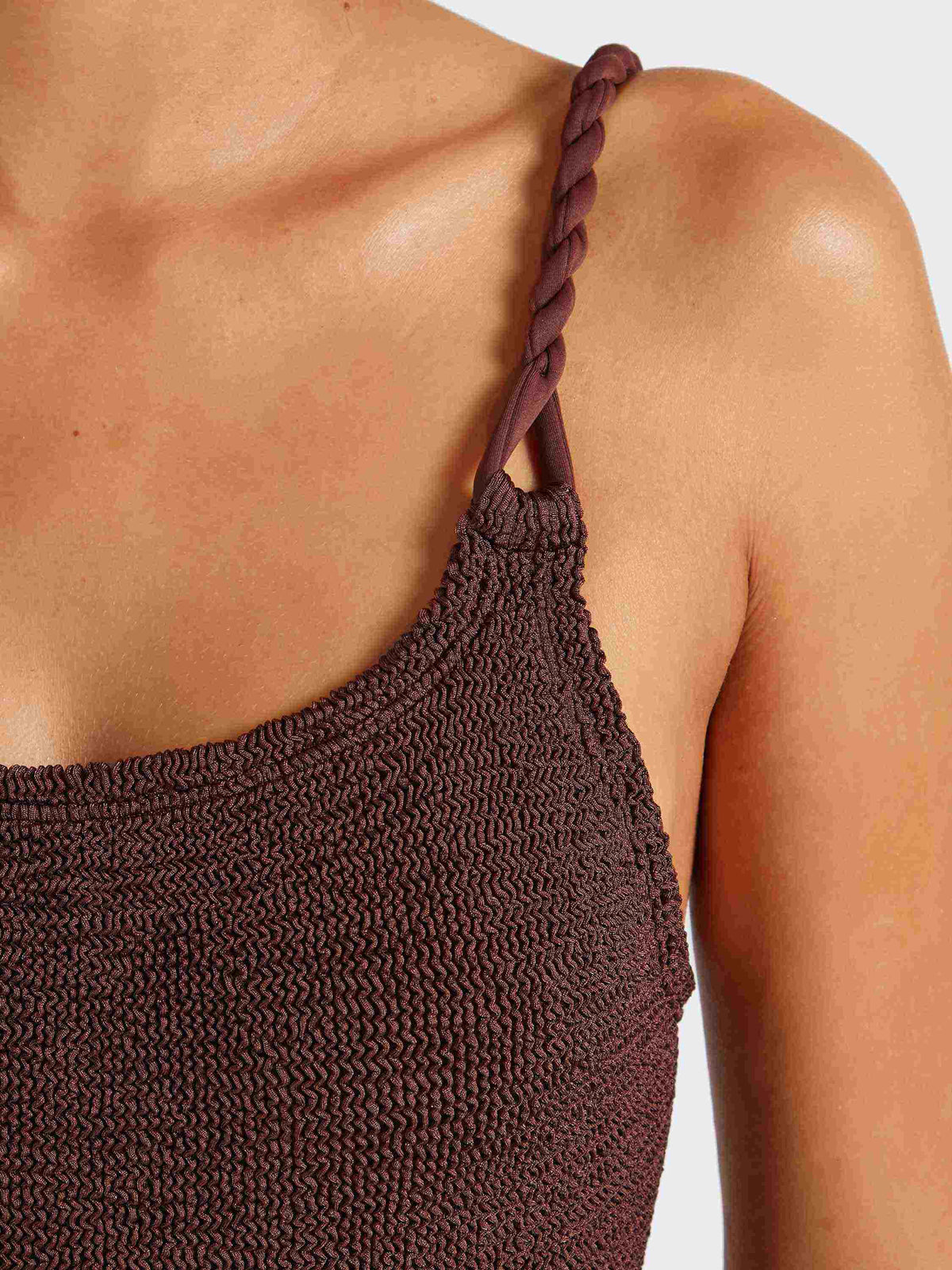 Close up of twisty shoulder strap of metallic chocolate Camille swimsuit
